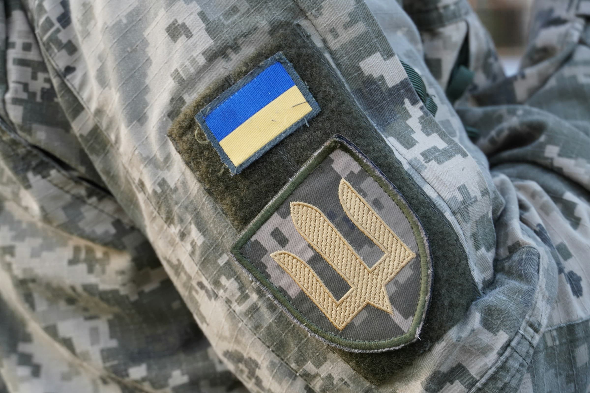 Ukrainian soldier's uniform showing national flag and trident patch